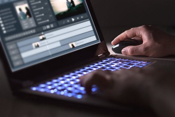 video editing software filmora 8 man editing movie on laptop 